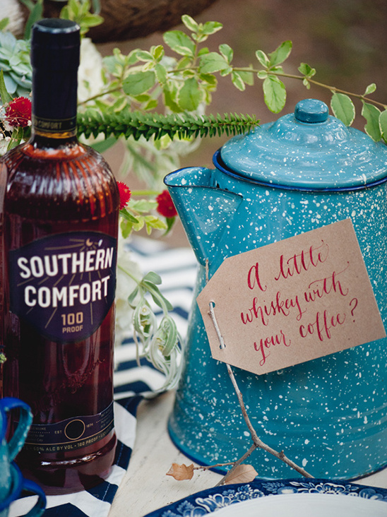 Southern Comfort whiskey bottle and a blue enamel coffee pot