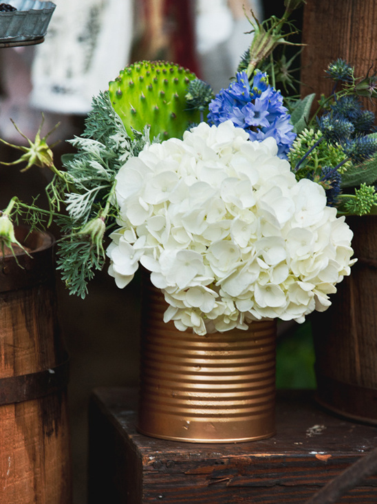 Hydrangea bouquet in a gold painted can on wood