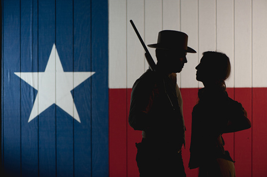 Couple silhouette before Texas flag backdrop