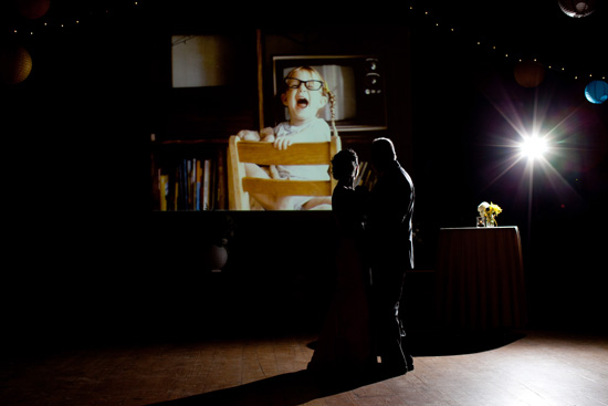 Couple dances in silhouette with vintage TV projection