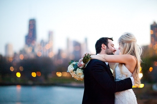 Romantic couple embraces in city skyline