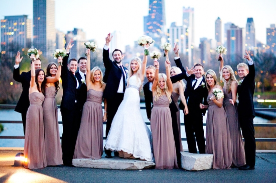 Happy wedding party celebrating in a city backdrop