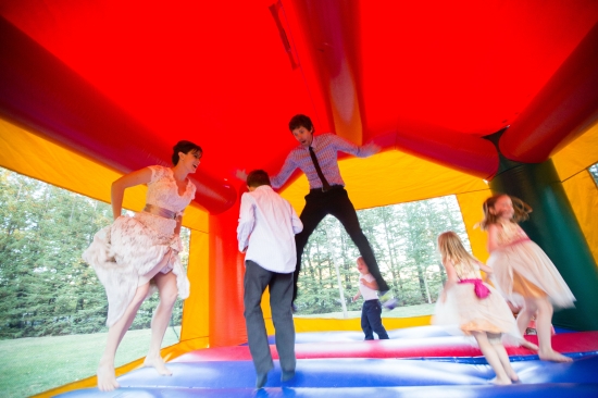 Happy people jumping on bouncy castle