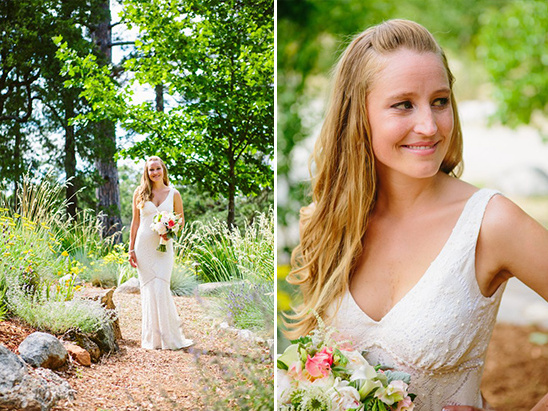 Bride in a white dress holding flowers, smiling in natural setting