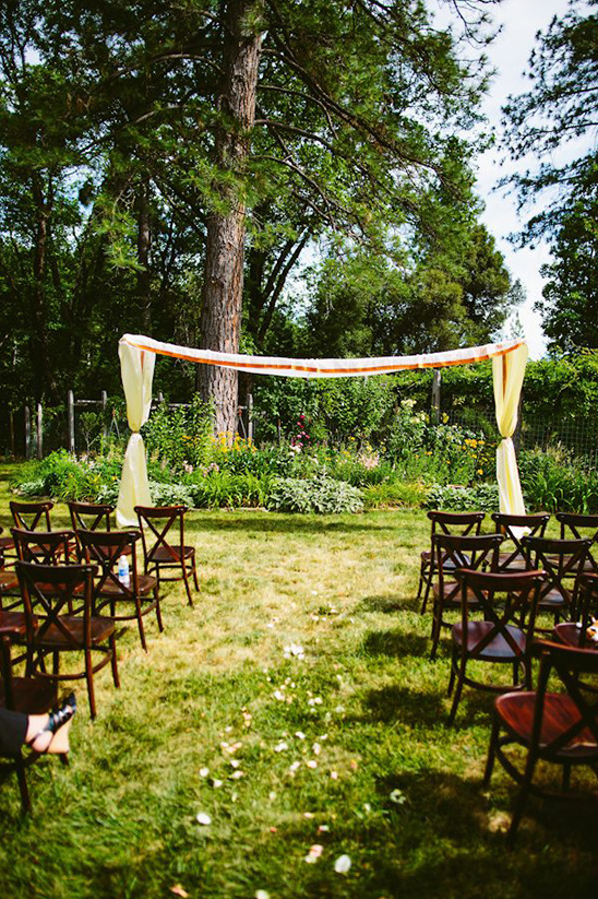 Outdoor wedding ceremony set up on the green lawn surrounded by trees
