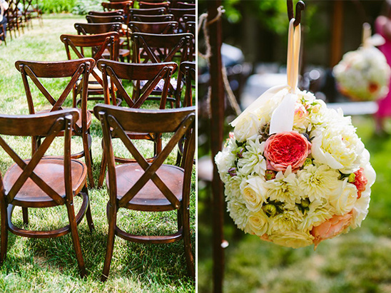 Wedding decor with wooden chairs and hanging floral arrangements