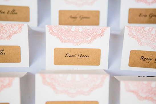 Place cards with pink lace design, names on kraft paper tags