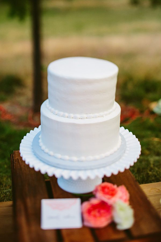 Two tiered white wedding cake on display