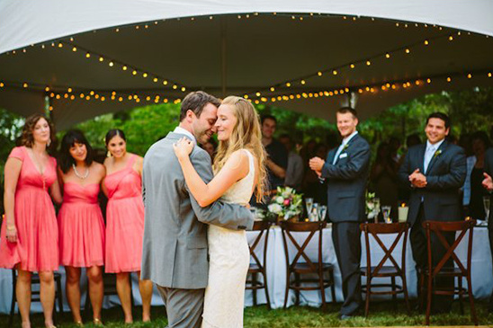 Bride and groom first dance under tent lights