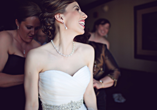 Bride laughing with bridesmaids before the wedding ceremony begins