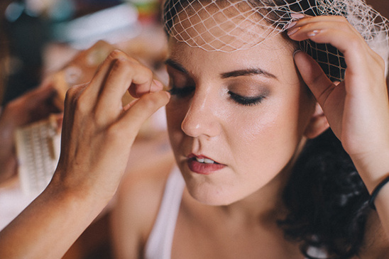 Bride getting makeup applied before a wedding ceremony