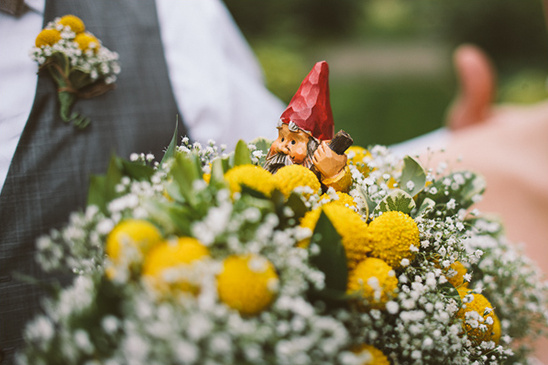 Gnome in a flower bouquet at a wedding with yellow flowers