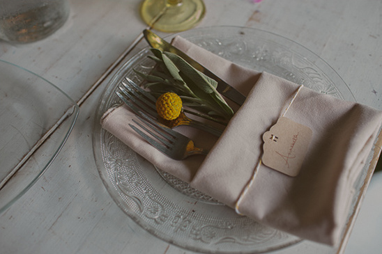 Elegant table setting with folded napkin, silverware, and place card