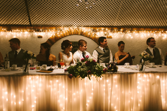 Wedding reception with decorative lights and wedding party at table