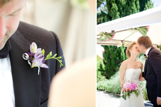 Groom with boutonniere and bride kissing at an outdoor wedding