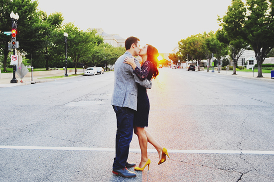Couple sharing a romantic kiss on the street at sunset with beautiful scenery