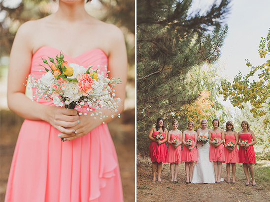 Bridesmaids in coral dresses hold bouquets at a wedding