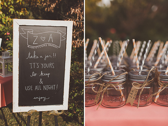 Wedding reception with mason jars and chalkboard sign with instructions