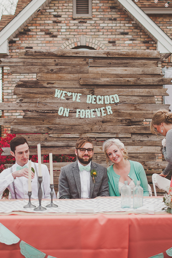 Wedding couple announces forever on rustic wood backdrop