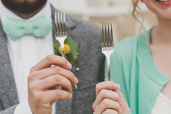 Bride and groom holding custom engraved wedding forks