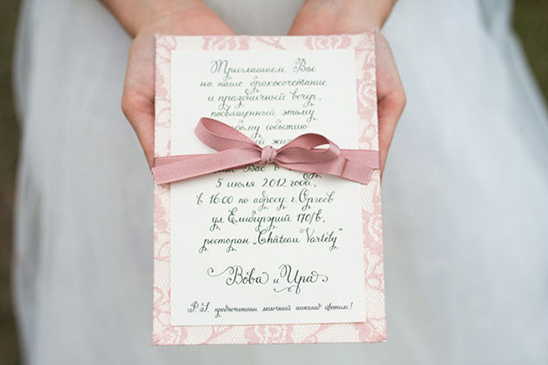 Elegant pink lace wedding invitation with calligraphy