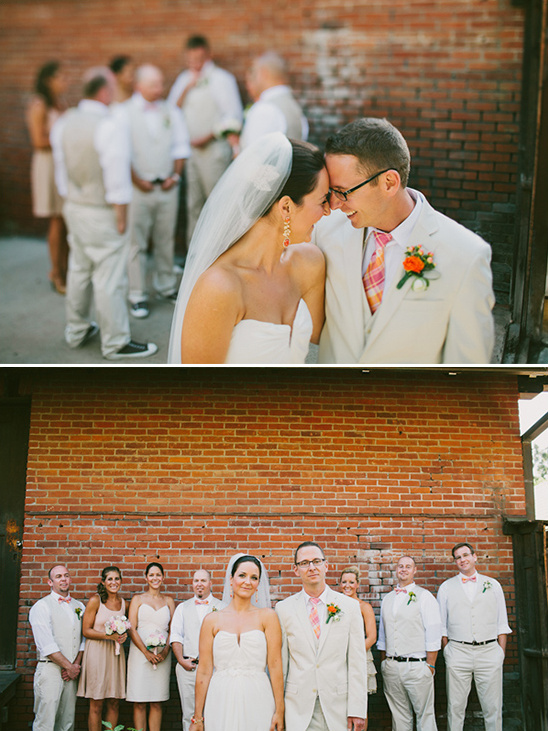 Wedding couple sharing a sweet moment with wedding party in the background