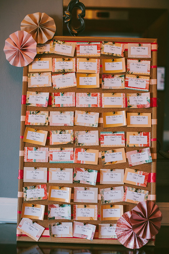 Wedding seating chart with floral cards and decorative fans