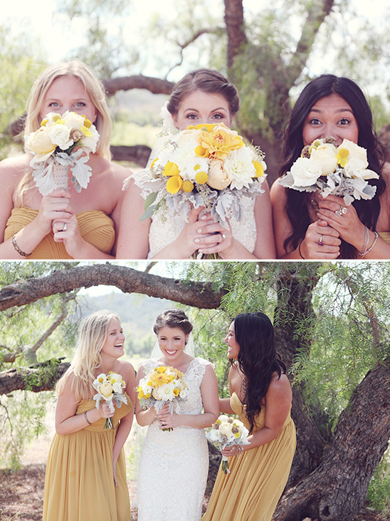 Bride and bridesmaids with bouquets at outdoor wedding