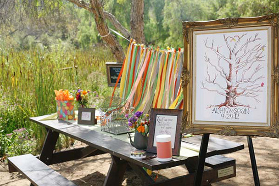 Wedding guest book table with tree drawing and ribbons