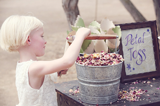 A young girl preparing for petal toss at a wedding ceremony