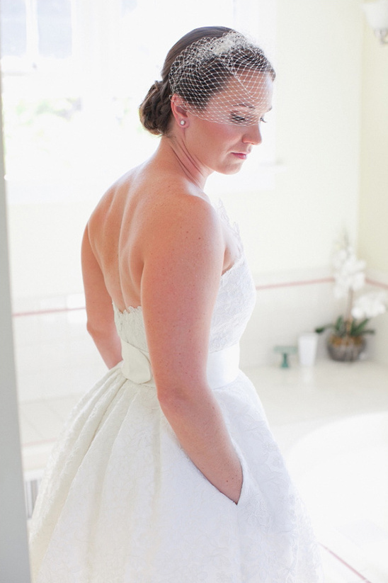 strapless tea length wedding gown paired with bird cage veil