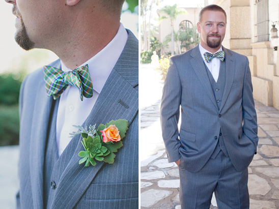 Groom in gray suit, green bow tie, floral boutonniere