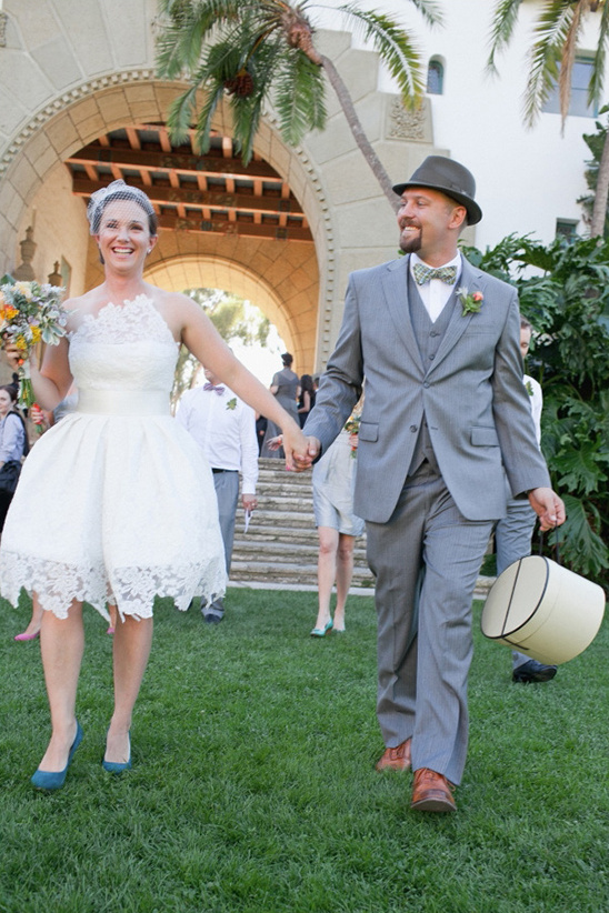 Happy bride and groom walking down the aisle