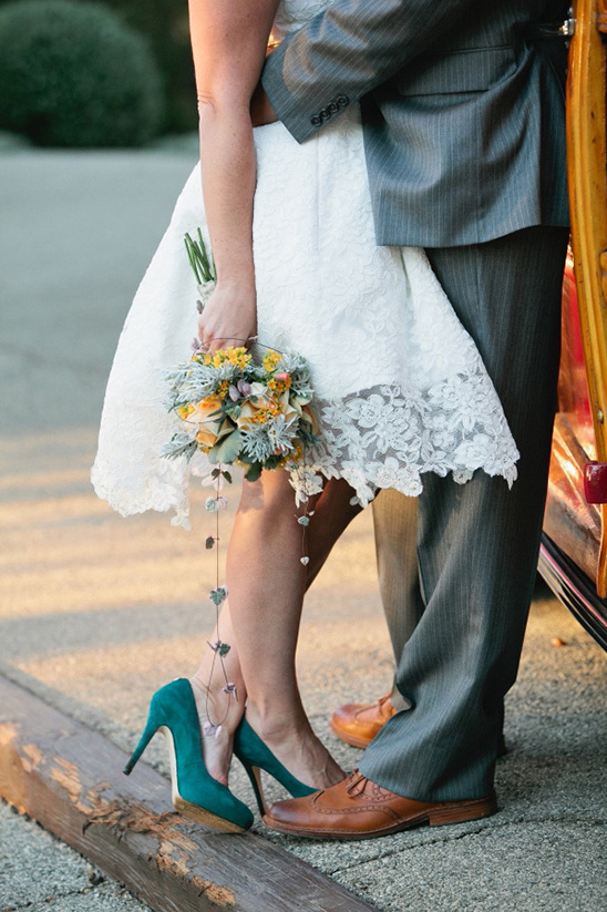 Bride and groom embrace, teal shoes, bouquet