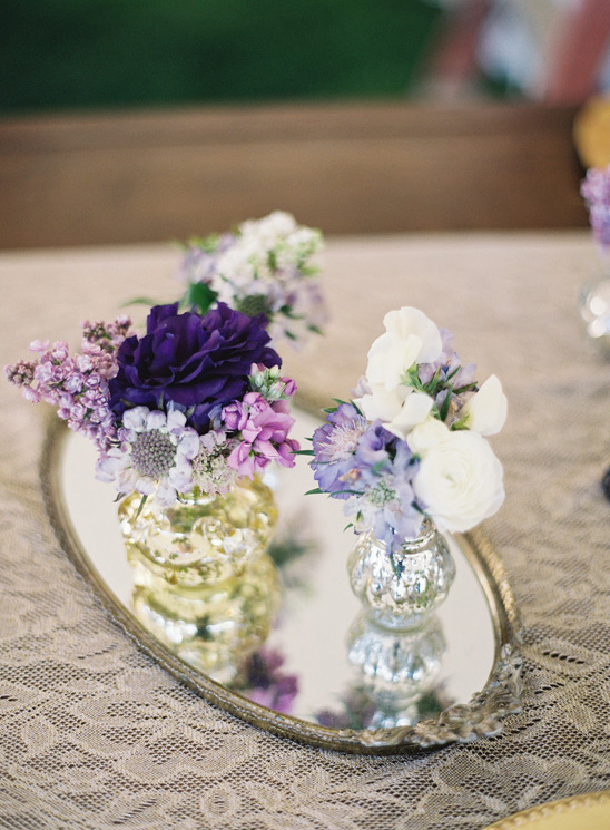 assorted mecury vases placed on a tray with purple florals