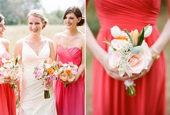 Bridesmaids smiling with bouquets in coral and blush dresses