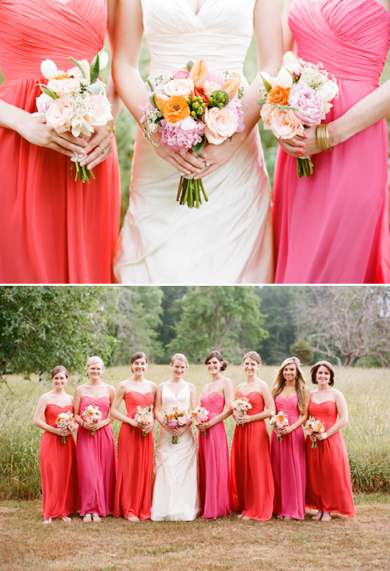 Wedding party wearing coral and pink dresses holding flowers