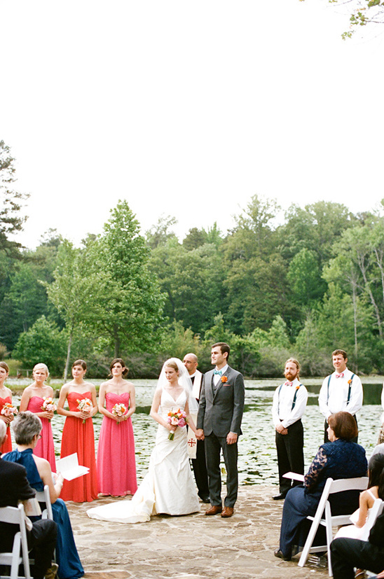 Wedding ceremony near a lake with bride and groom