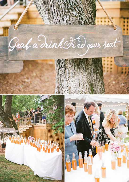 Wedding reception drinks table with sign and guests