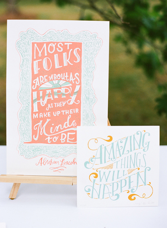 Hand-lettered inspirational quotes on display with wooden stand