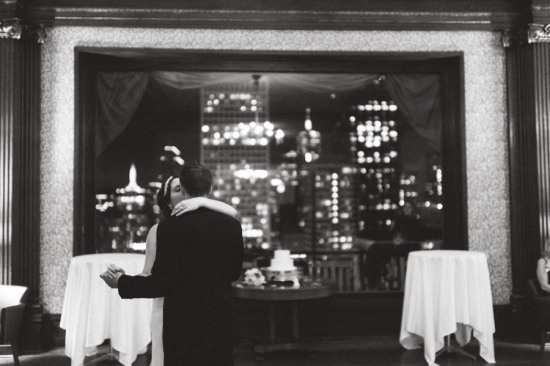 Bride and groom's first dance city skyline view