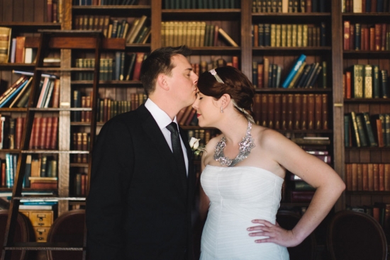Couple kissing in library wedding photo