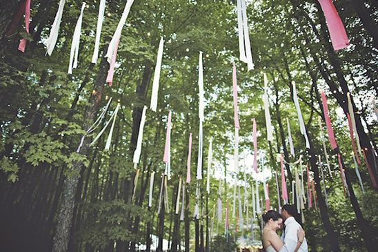Wedding couple in forest with ribbons decorations, lovely scene