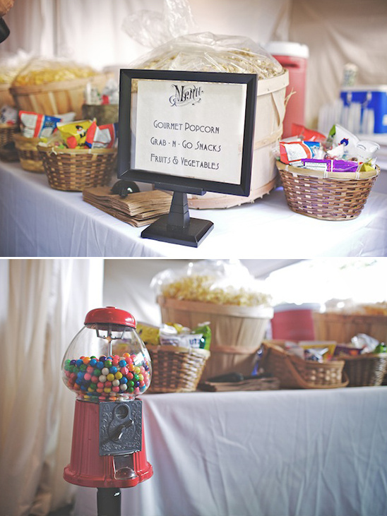 Snack bar with popcorn, gumball machine, and menu sign on display