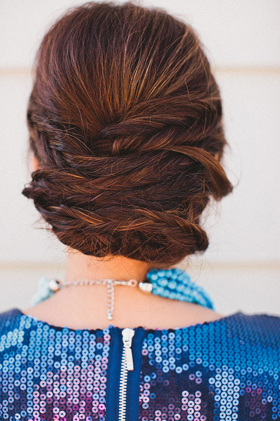 Elegant braided updo hairstyle with a blue sequin dress