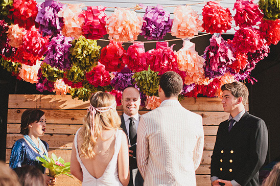 Vibrant wedding ceremony backdrop with colorful floral decorations