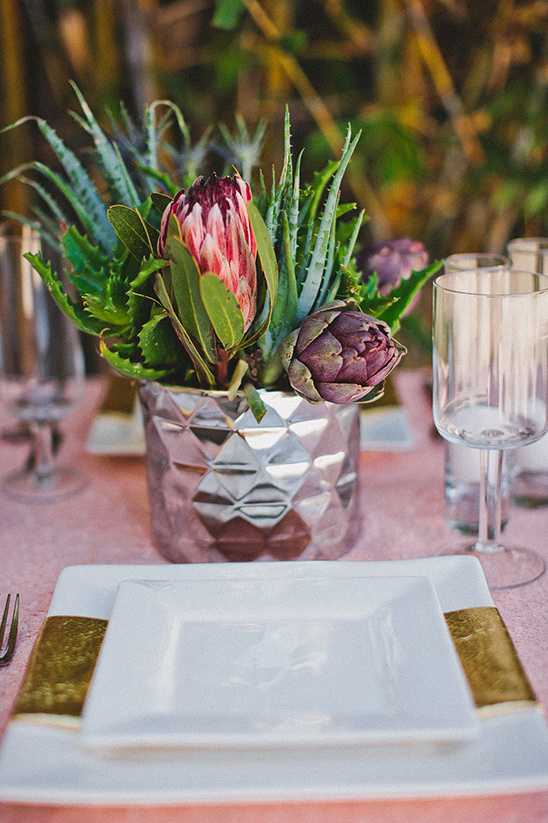 Elegant table setting with floral centerpiece and gold accents