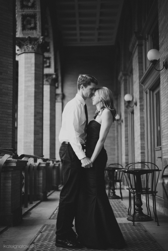 Elegant couple sharing a tender moment on a romantic, historic promenade