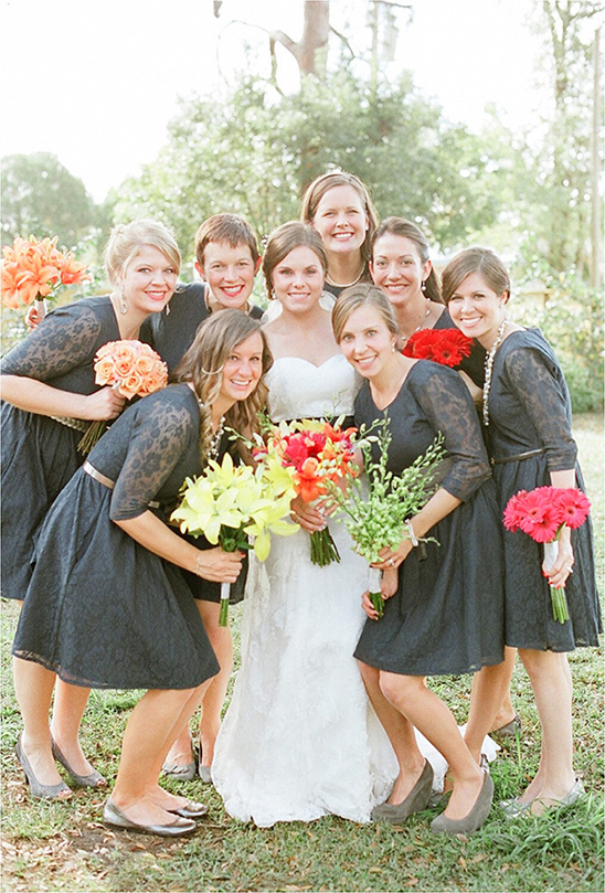 Bride with bridesmaids in lace dresses and bouquets