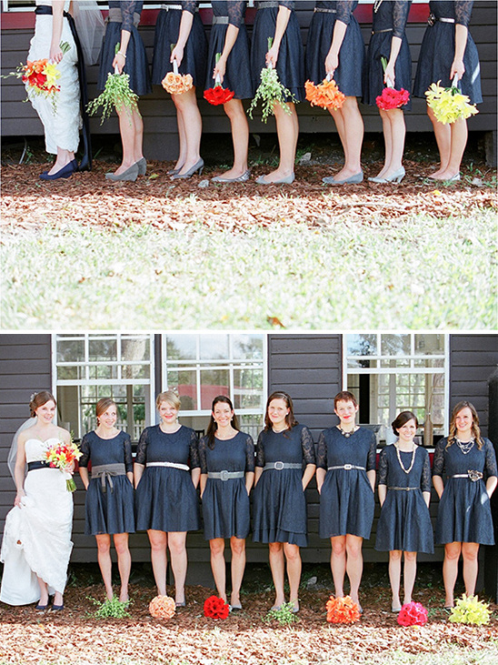 Bridesmaids in navy dresses with colorful bouquets